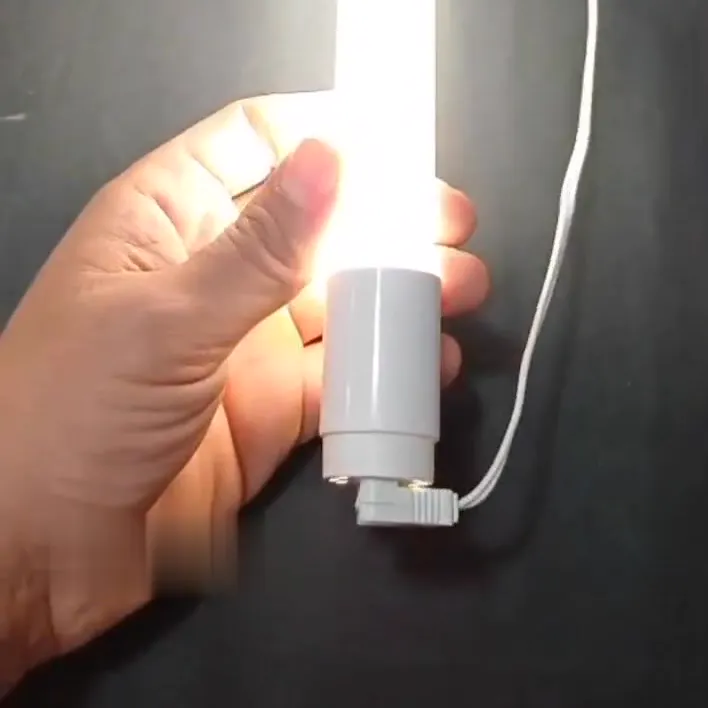 Lit 120 cm T8 LED tube held in a hand